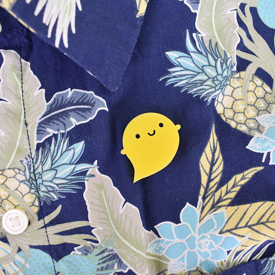 The yellow Rainbow Ghost brooch pinned to a tropical themed shirt