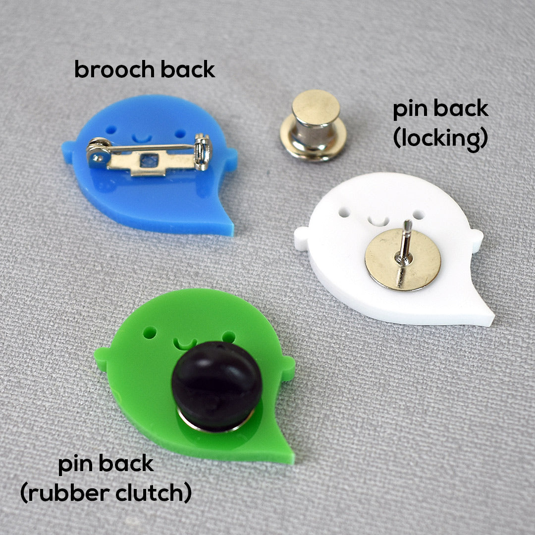 Examples of a brooch back, pin back, rubber clutch and locking back