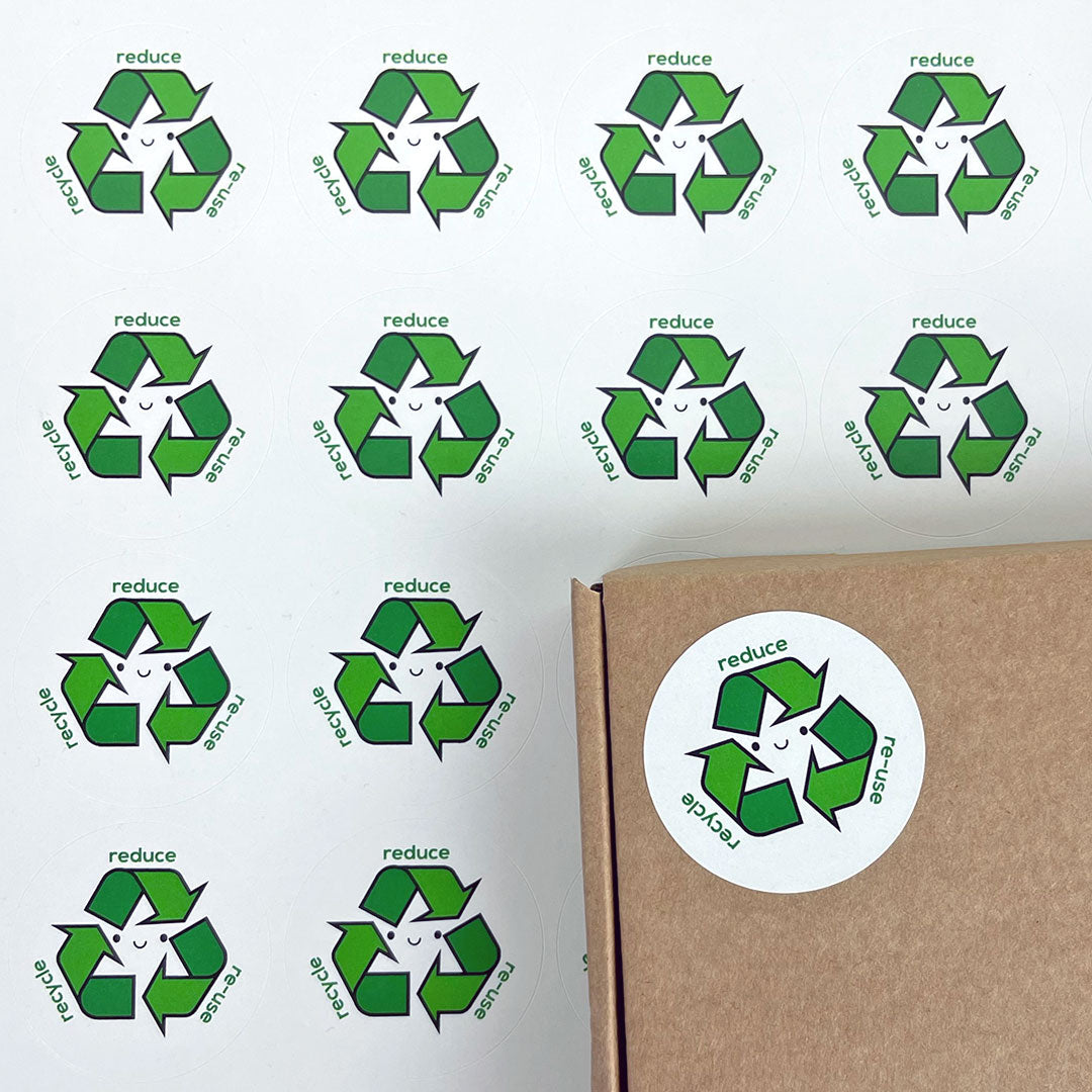 A sheet of Reduce Re-use Recycle stickers plus a package decorated with another sticker