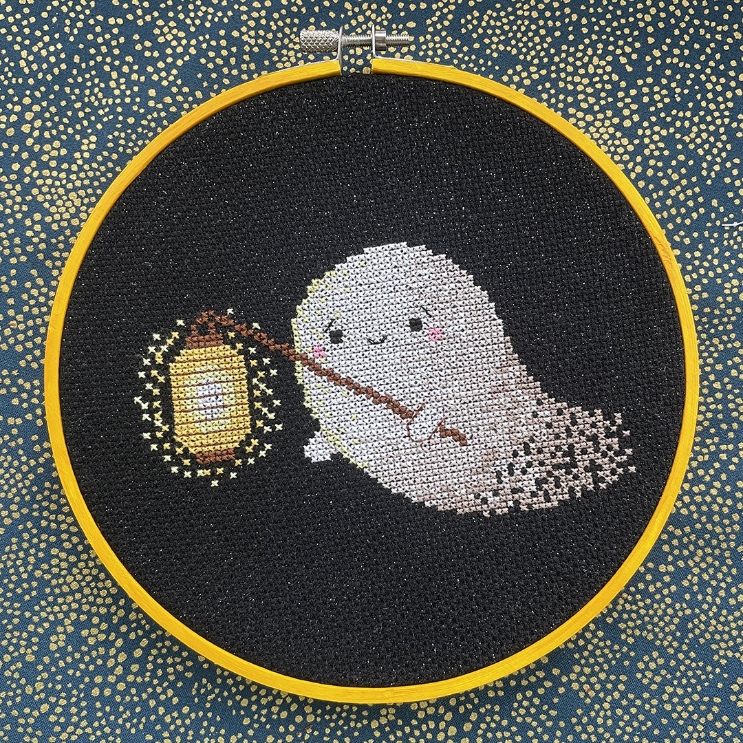 The aida used for a cute ghost cross stitch design framed in a hoop