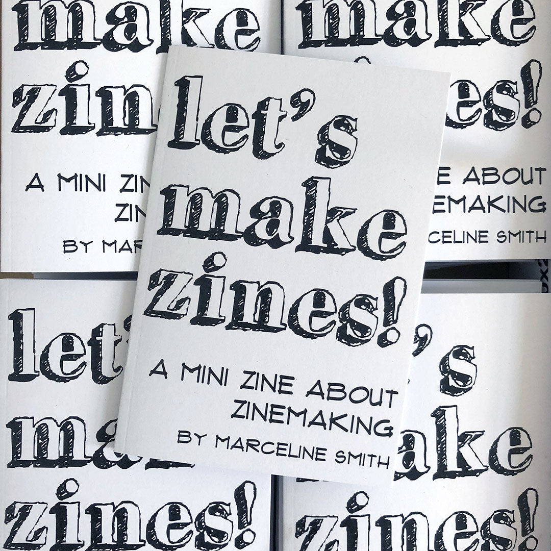 A stack of zines - the cover is black and white with the text 'Let's Make Zines! A mini zine about zinameking by Marceline Smith'