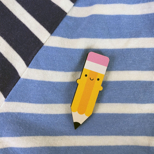 A happy kawaii Pencil brooch made from ethically sourced, FSC certified wood