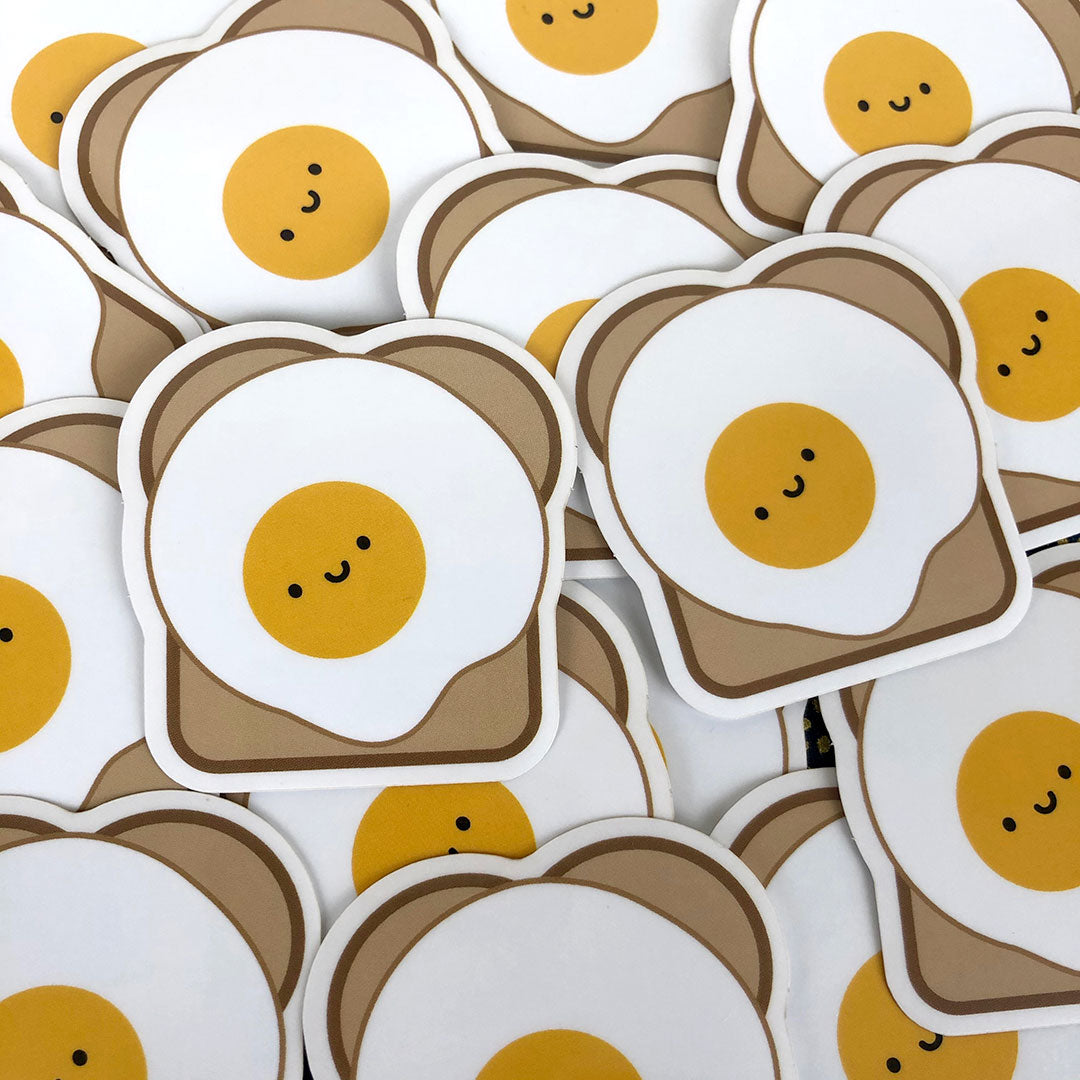 A scattered pile of Egg on Toast stickers