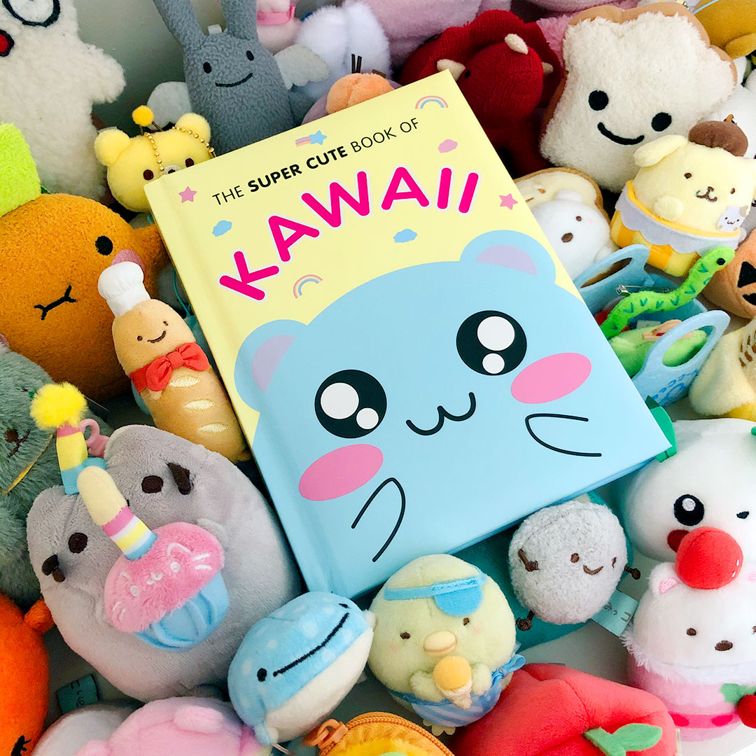 The Super Cute Book of Kawaii sitting on a pile of plush toys
