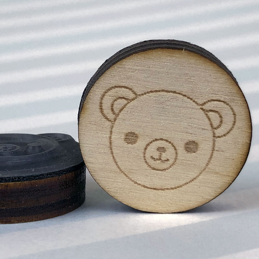 Close up of 2 Bear stamps showing the laser engraving and height