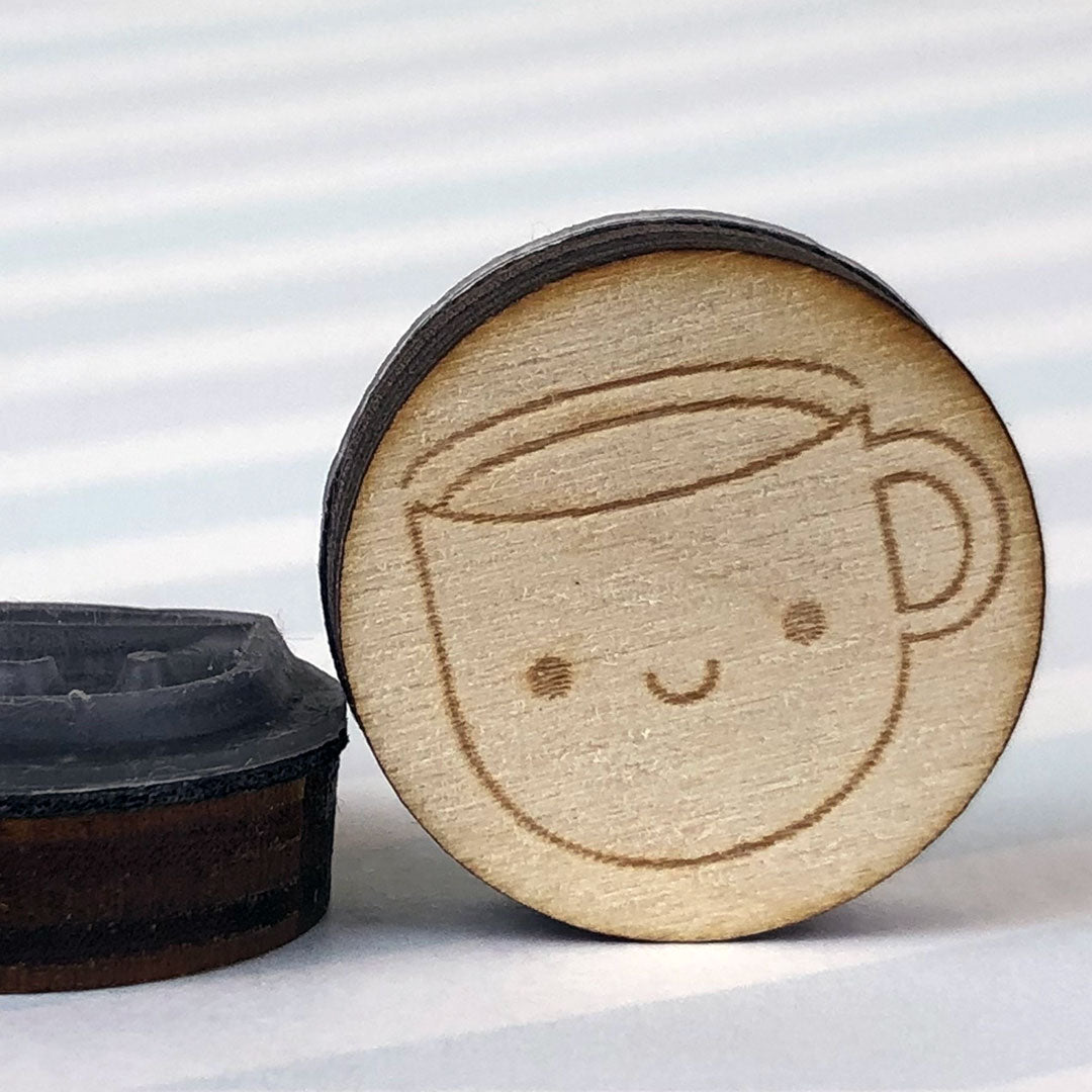 Close up of 2 Cup of Tea stamps showing the laser engraving and height