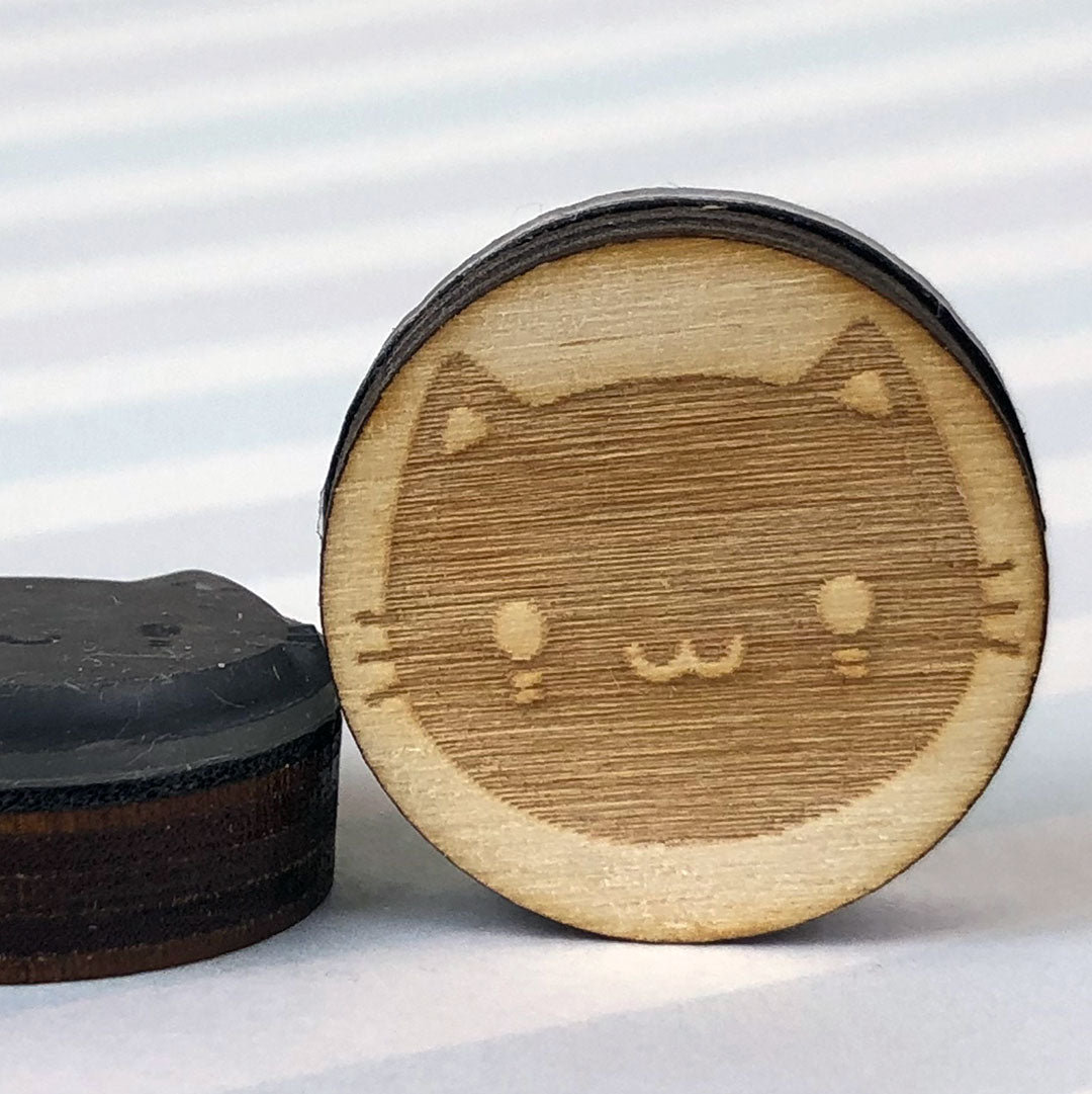 Close up of 2 Black Cat stamps showing the laser engraving and height