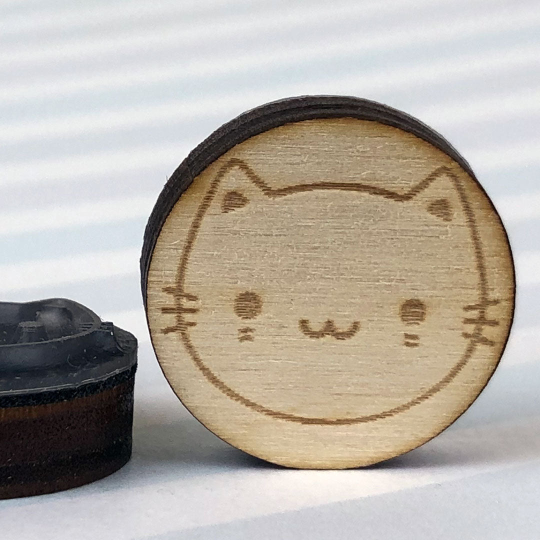 Close up of 2 White Cat stamps showing the laser engraving and height