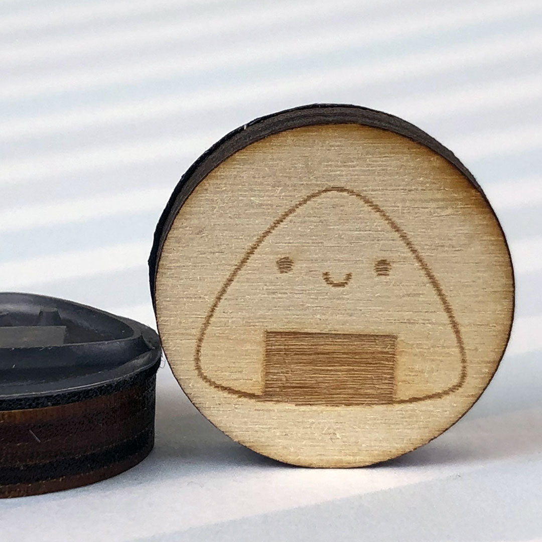 Close up of 2 Onigiri stamps showing the laser engraving and height