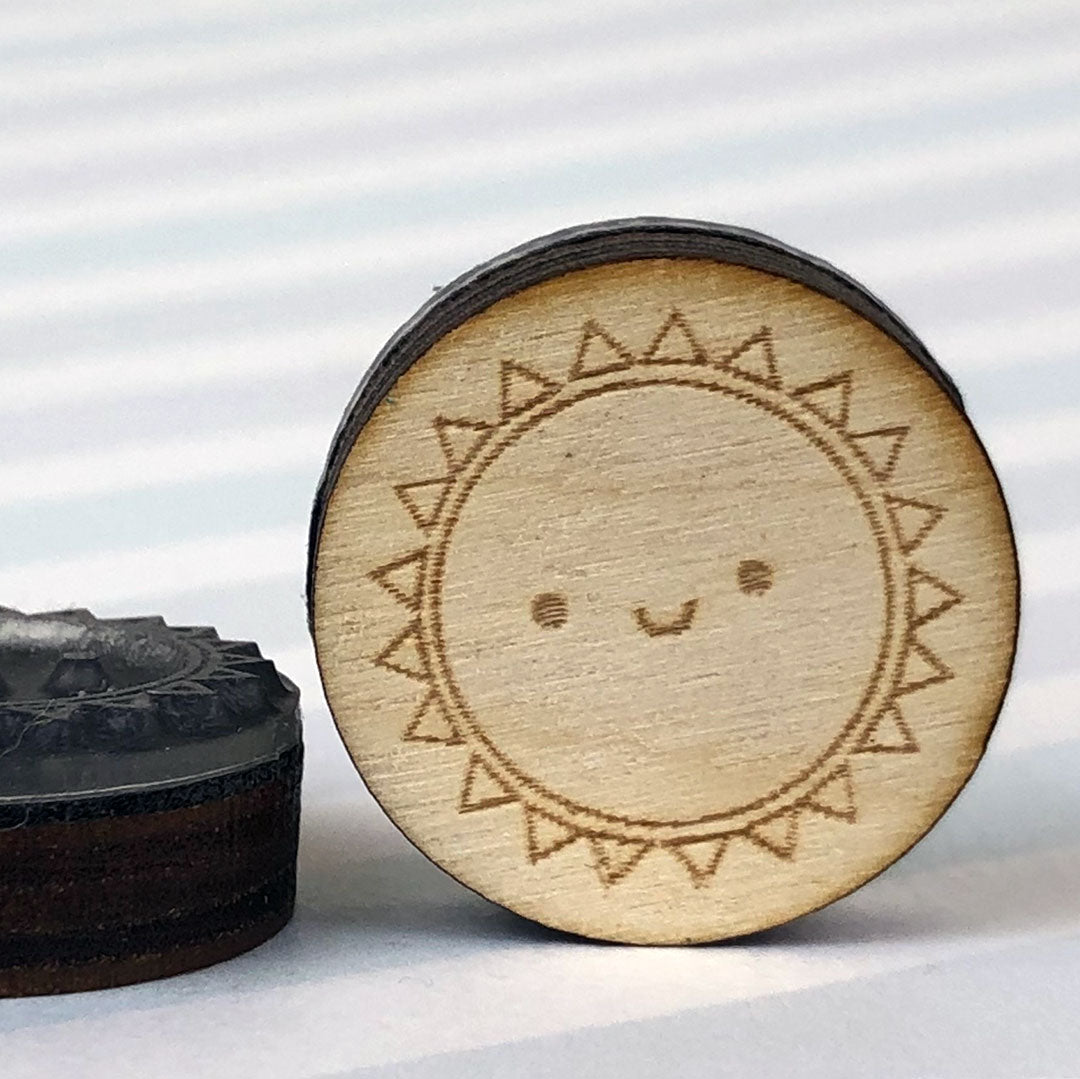 Close up of 2 Sun stamps showing the laser engraving and height