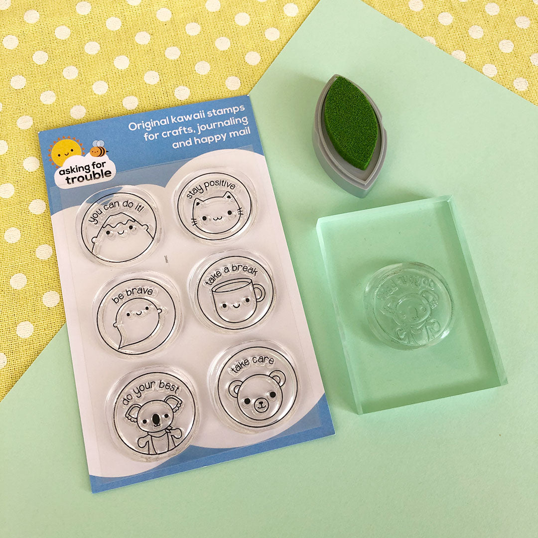 A stamp set with a stamp attached to a clear block and an ink pad