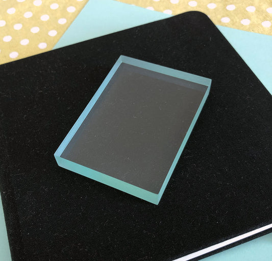 A clear acrylic block used for stamping