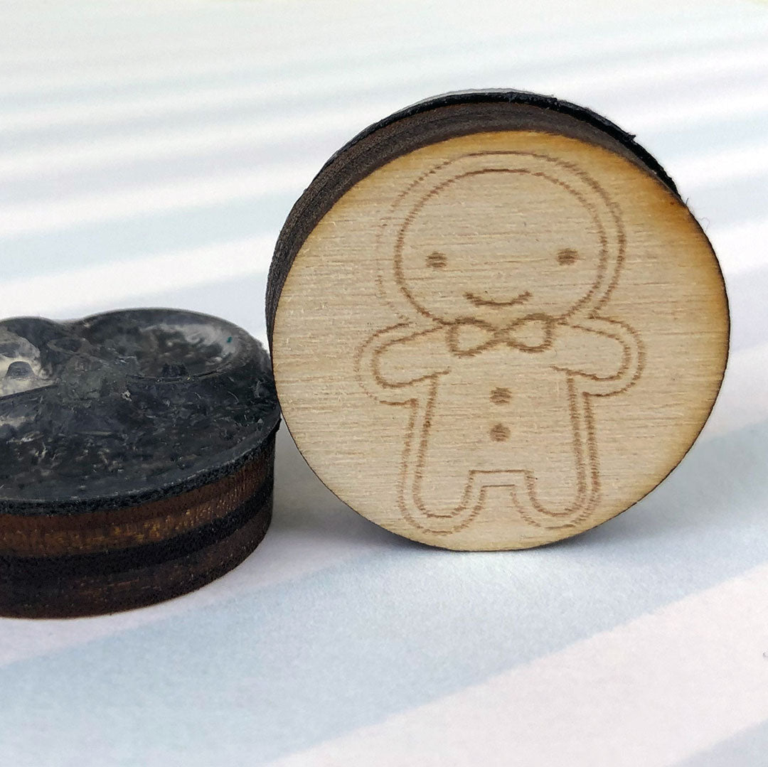 Close up of 2 happy Gingerbread Man stamps showing the laser engraving and height