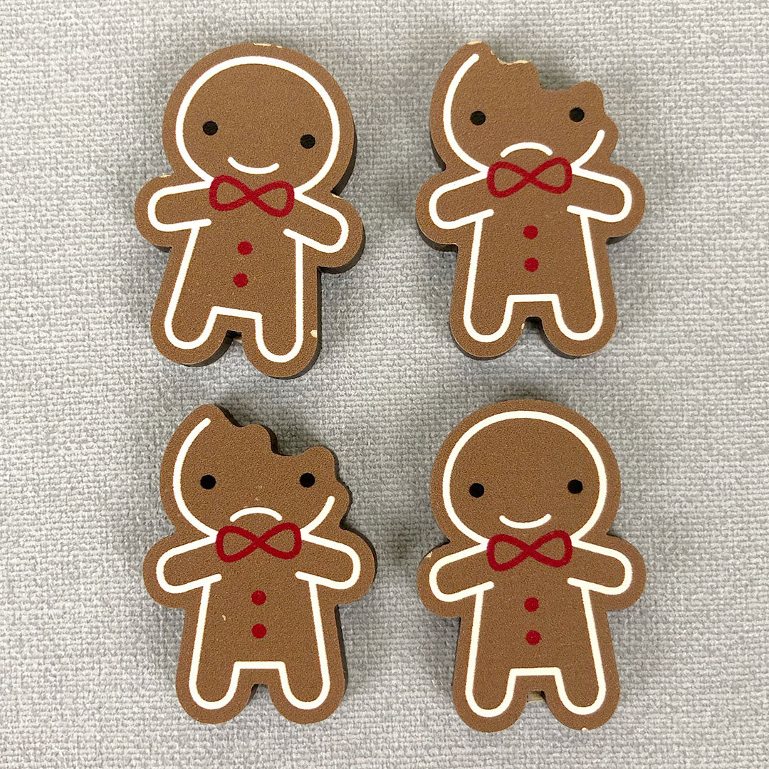 Damaged Gingerbread Man wooden brooches with small parts of the design missing around the edges