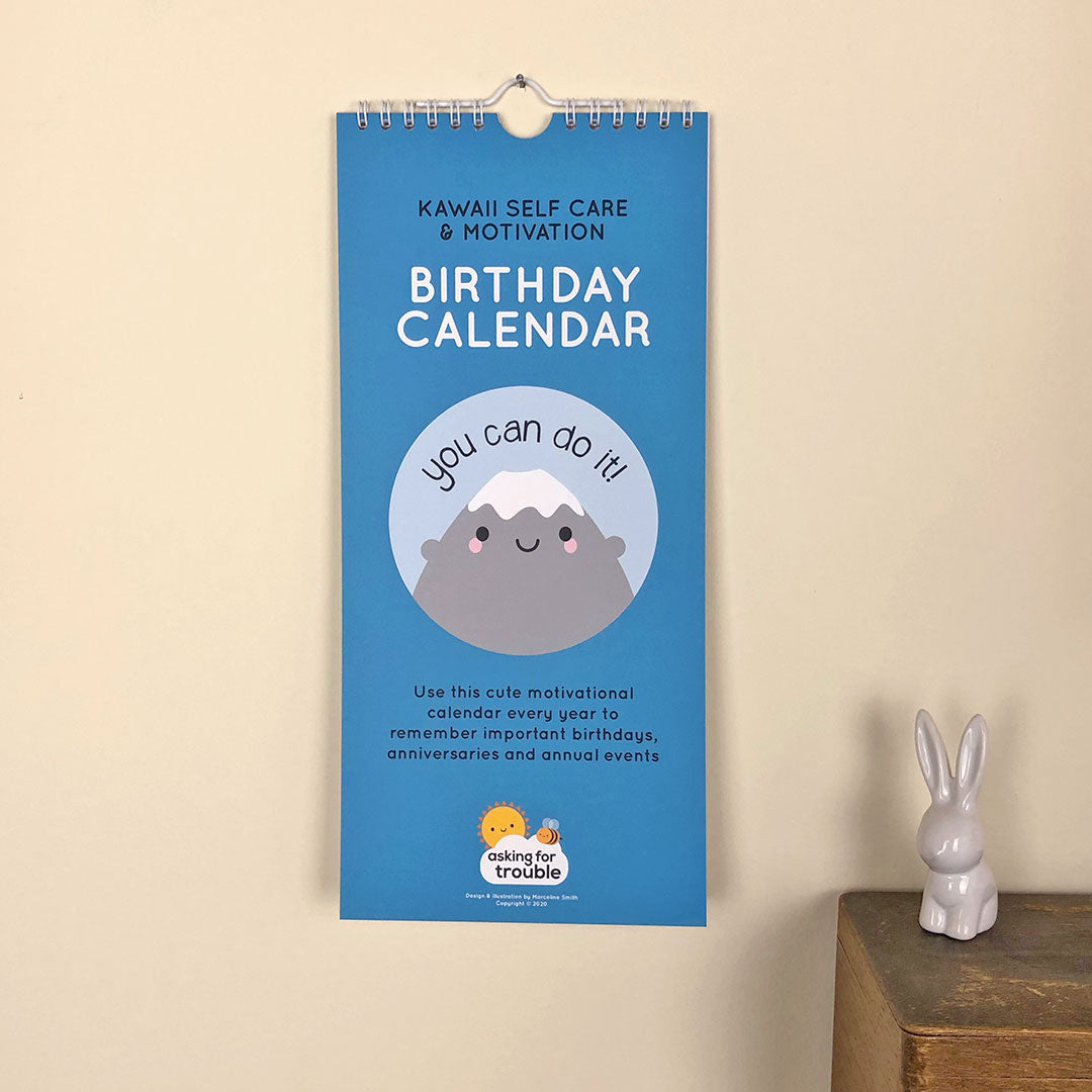 The birthday calendar hanging up showing the cute illustrated cover (Mt Fuji saying 'you can do it!')