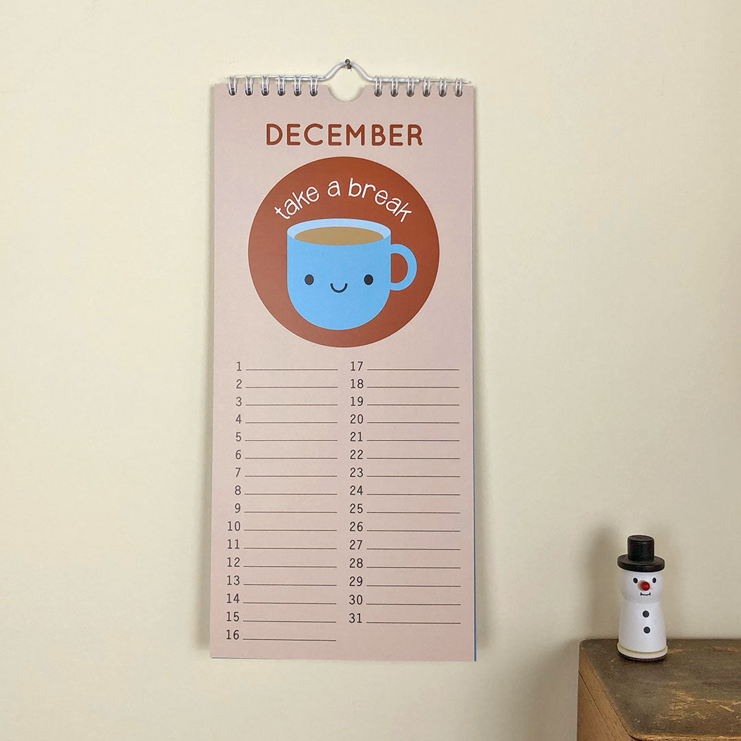 The birthday calendar hanging up showing the page for December with a kawaii tea cup saying 'take a break' and lines for each date