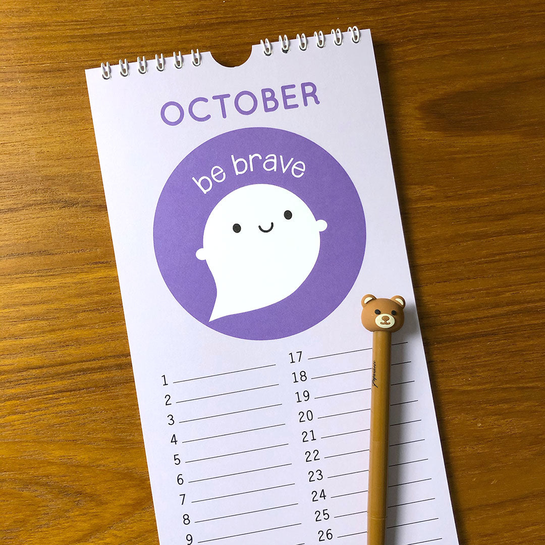 A close up of the page for October with a kawaii Ghost saying 'be brave' and lines for each date