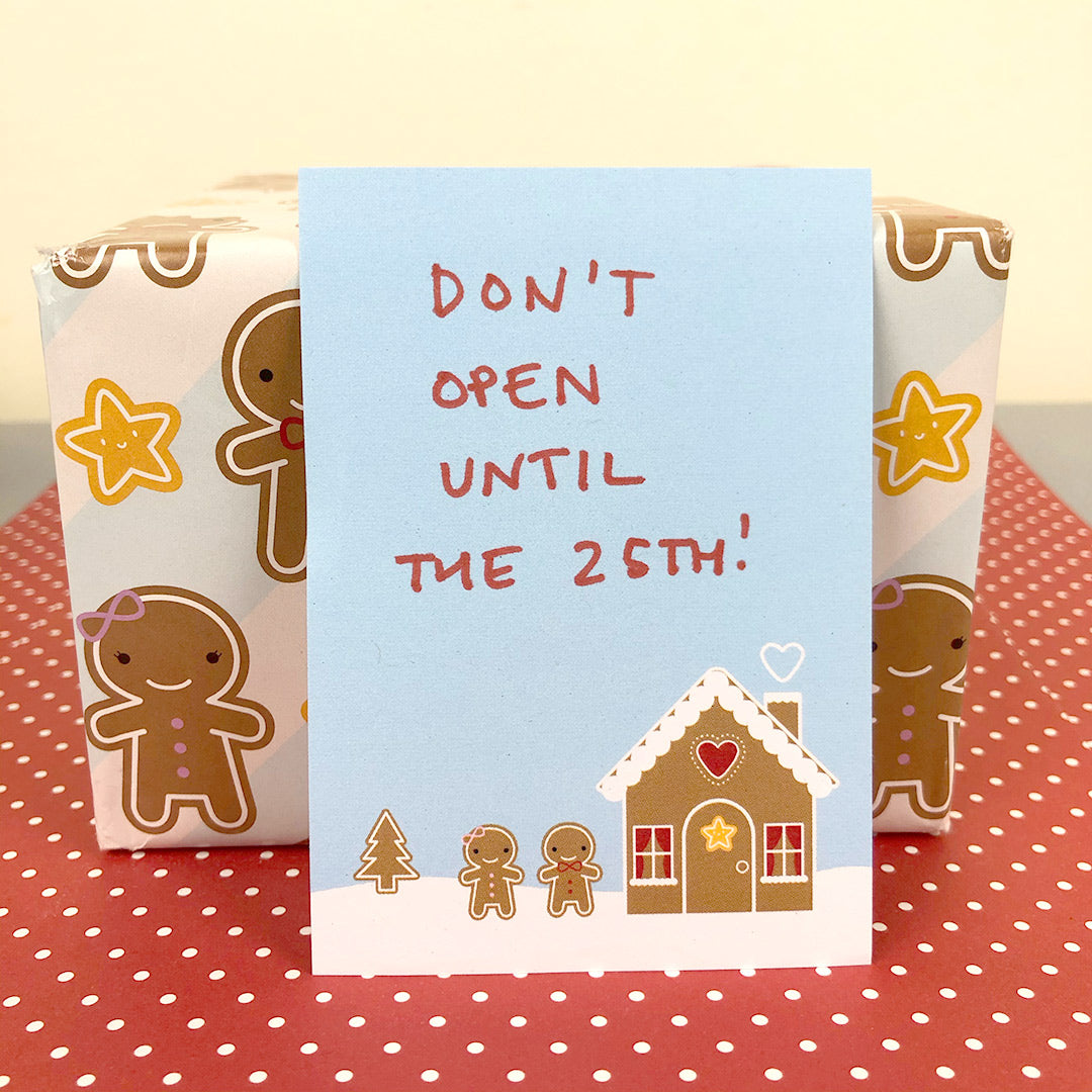 Gingerbread House memo sheet with hand-written note saying 'don't open until the 25th!' and a wrapped present