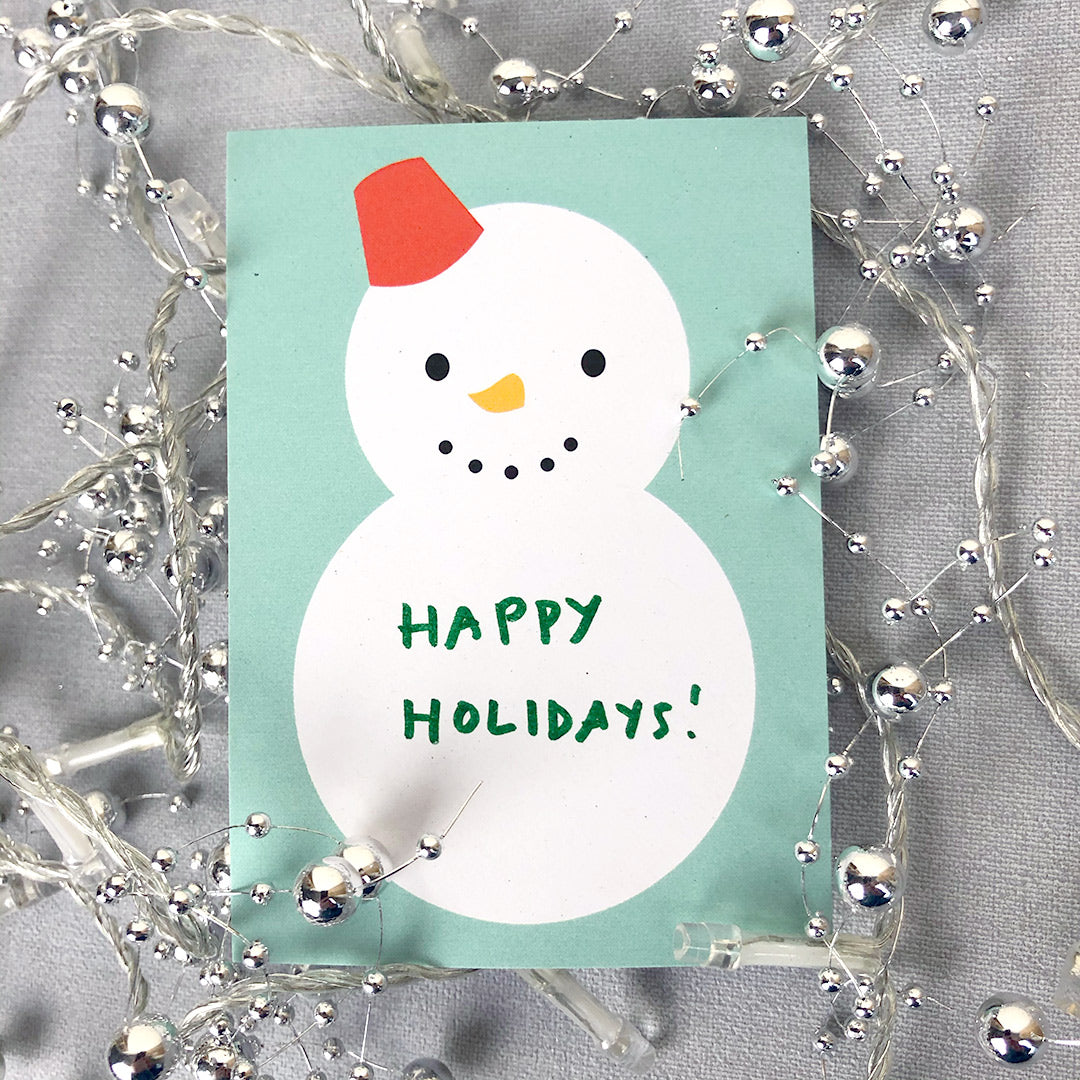Snowman memo sheet with hand-written note saying 'Happy Holidays!'