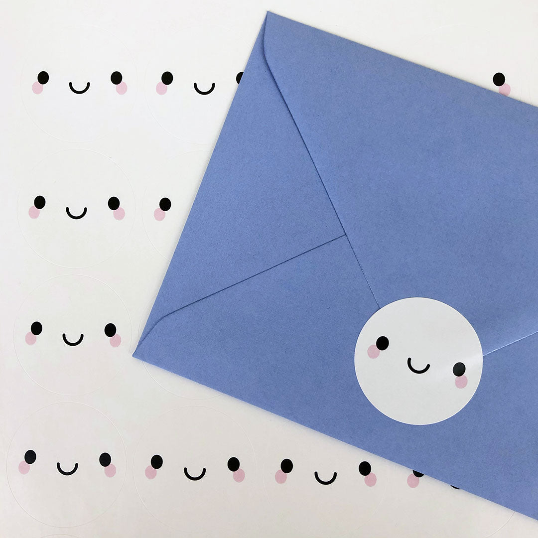 A sheet of Smiley Face stickers plus an envelope sealed with another sticker