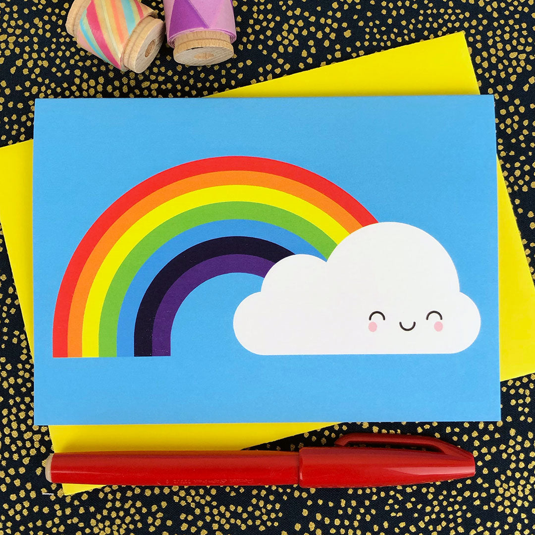 An illustrated card with a happy cloud and rainbow on a bright blue background