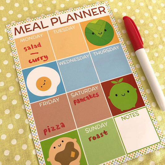 Example of dry erase meal planner magnet in use with hand-written notes and pen for scale