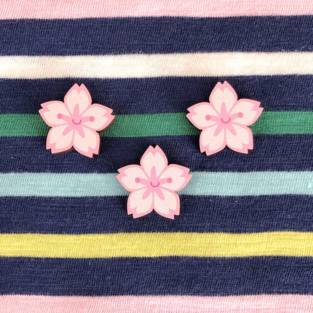 3 Sakura brooches pinned to a striped t-shirt