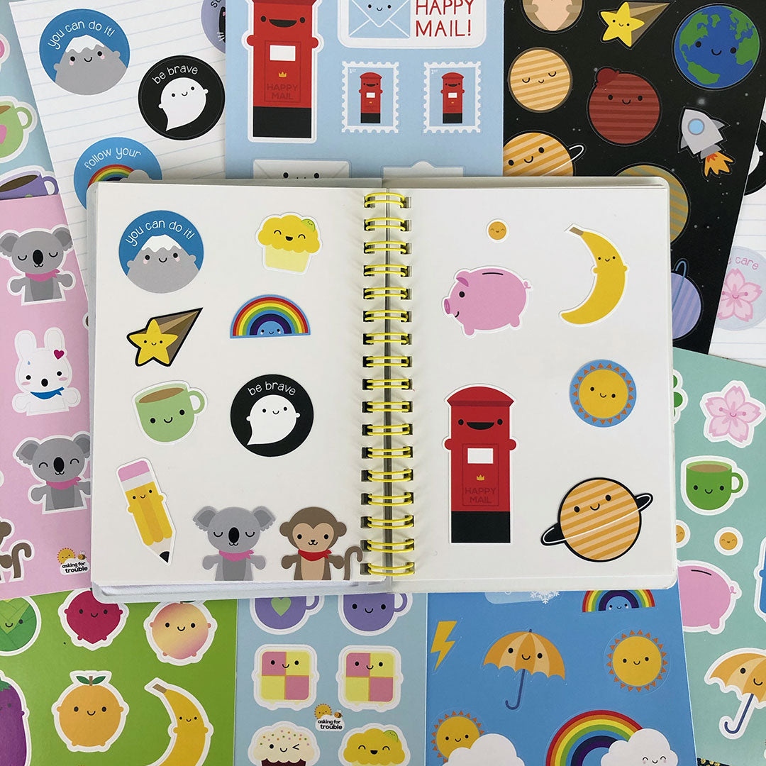 All sticker sheet designs with a sticker book laid on top decorated with a selection of stickers
