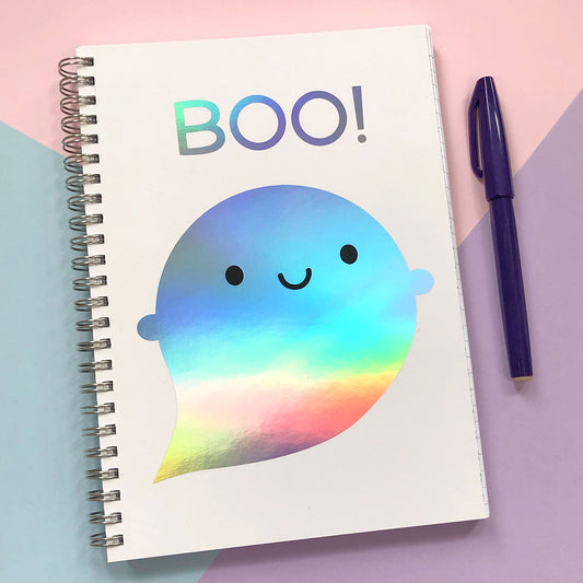 Spiral bound notebook with a happy kawaii ghost and the word BOO!, both in rainbow holographic foil