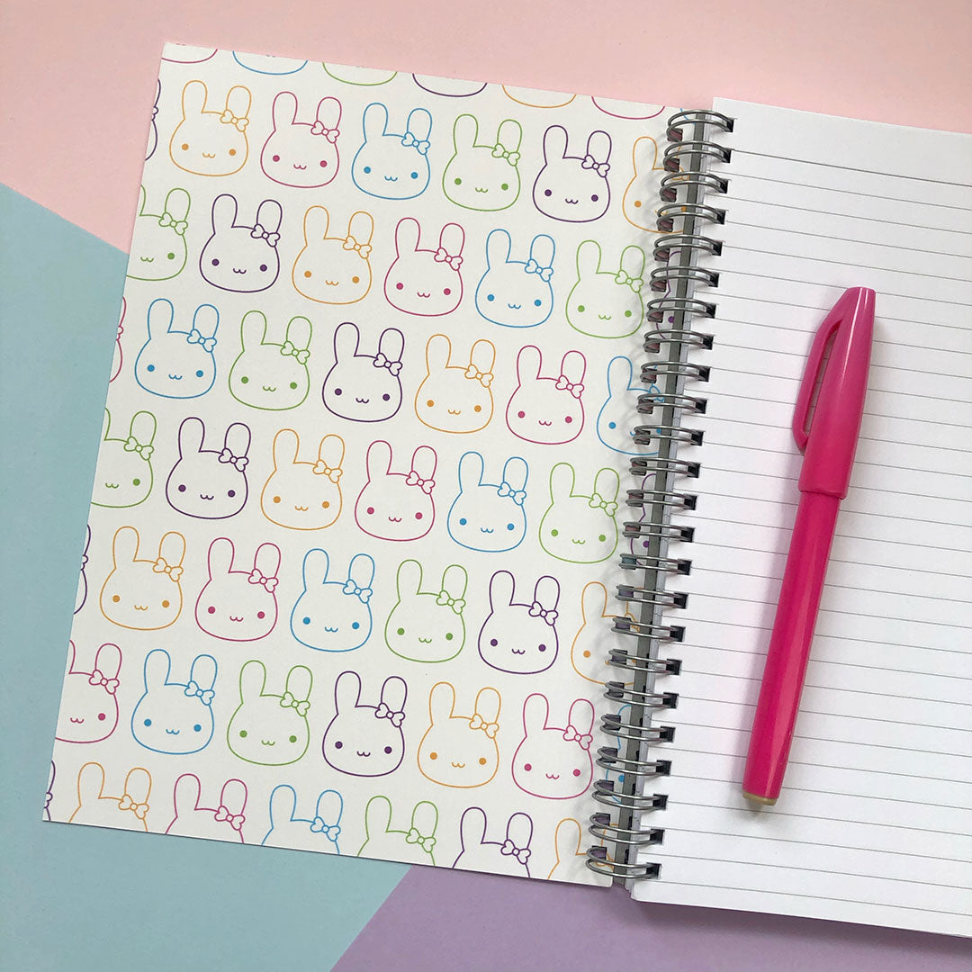 Inside the front cover is a repeat pattern of rainbow bunnies and all pages are lined