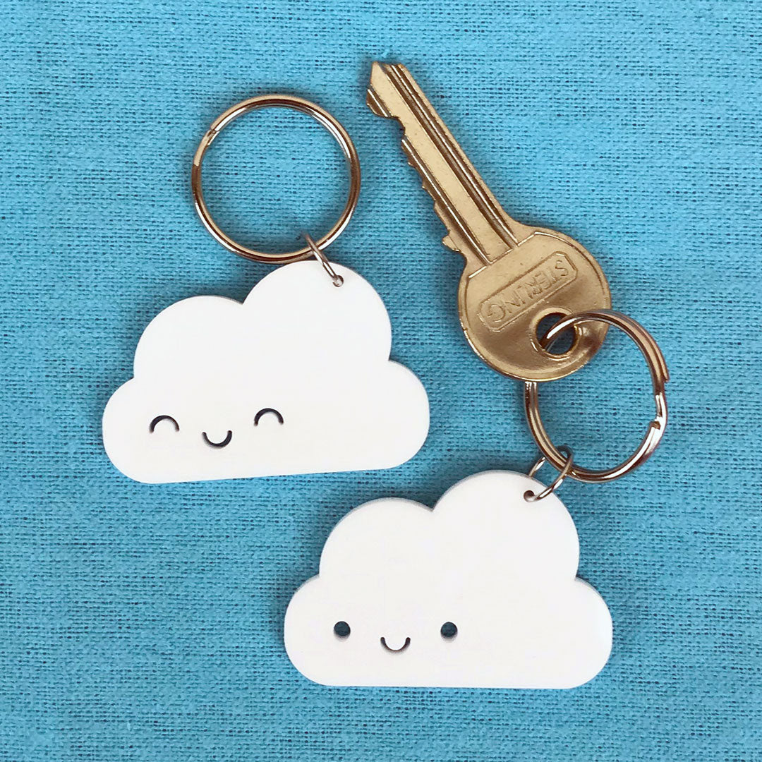 Happy Cloud keyrings with open and closed eyes laser cut from white acrylic, each with a split ring attached