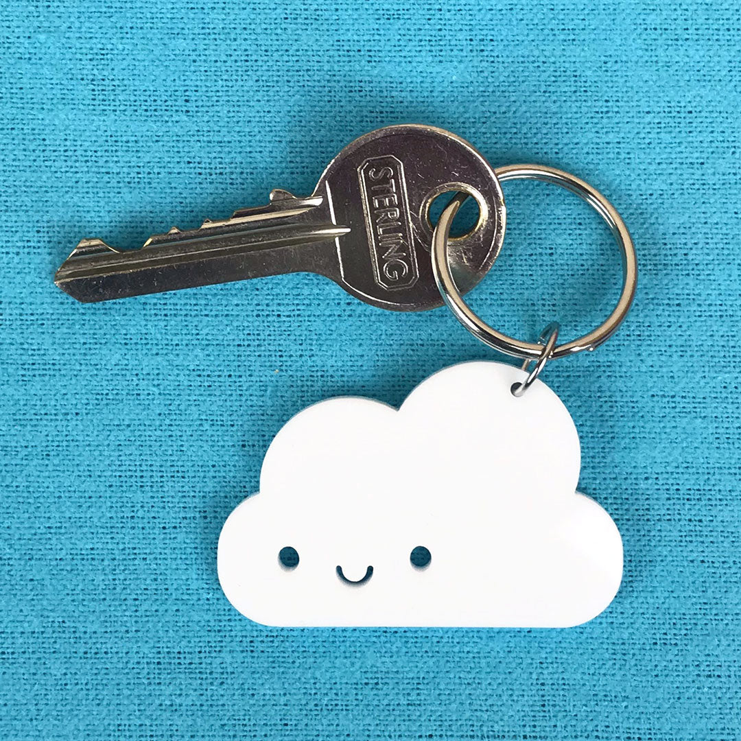 A Happy Cloud keyring with open eyes with a split ring and key attached