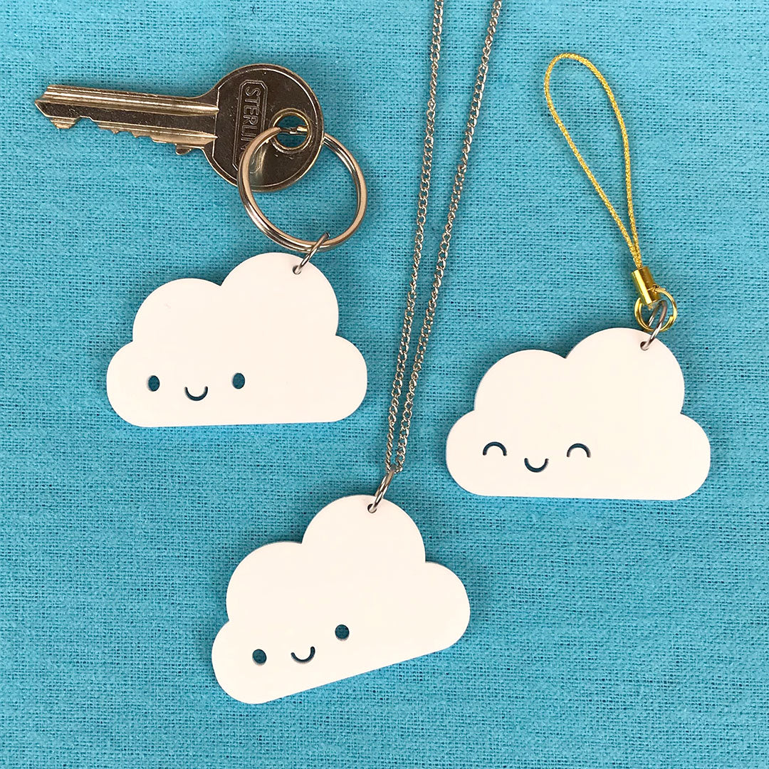Examples of Happy Cloud keyrings with a key and as a necklace or phone charm
