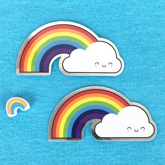 Two die cut vinyl stickers of a happy rainbow and cloud