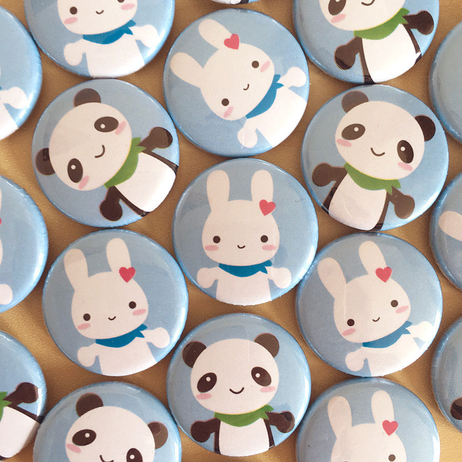 A mix of the finished Bunny & Panda badges laid out together