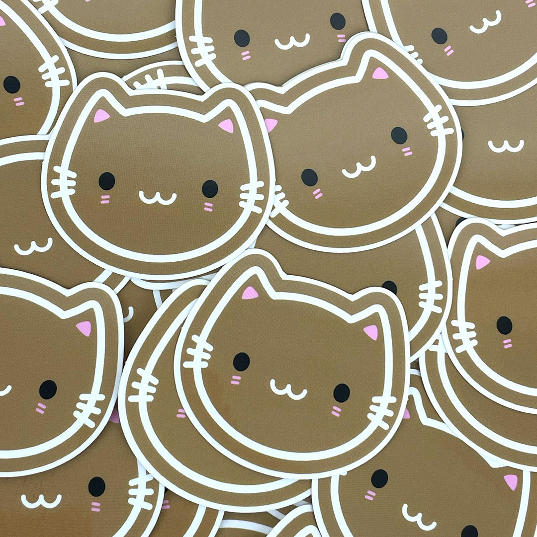 A scattered pile of Cookie Cats vinyl stickers