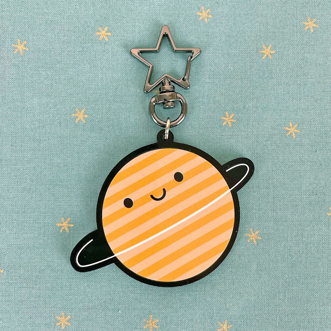 A happy planet shaped keyring with full colour print and star keychain