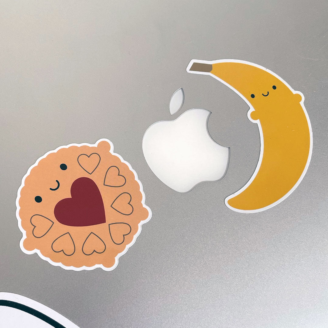 Jammie Dodger & Banana vinyl sticker on an Apple laptop