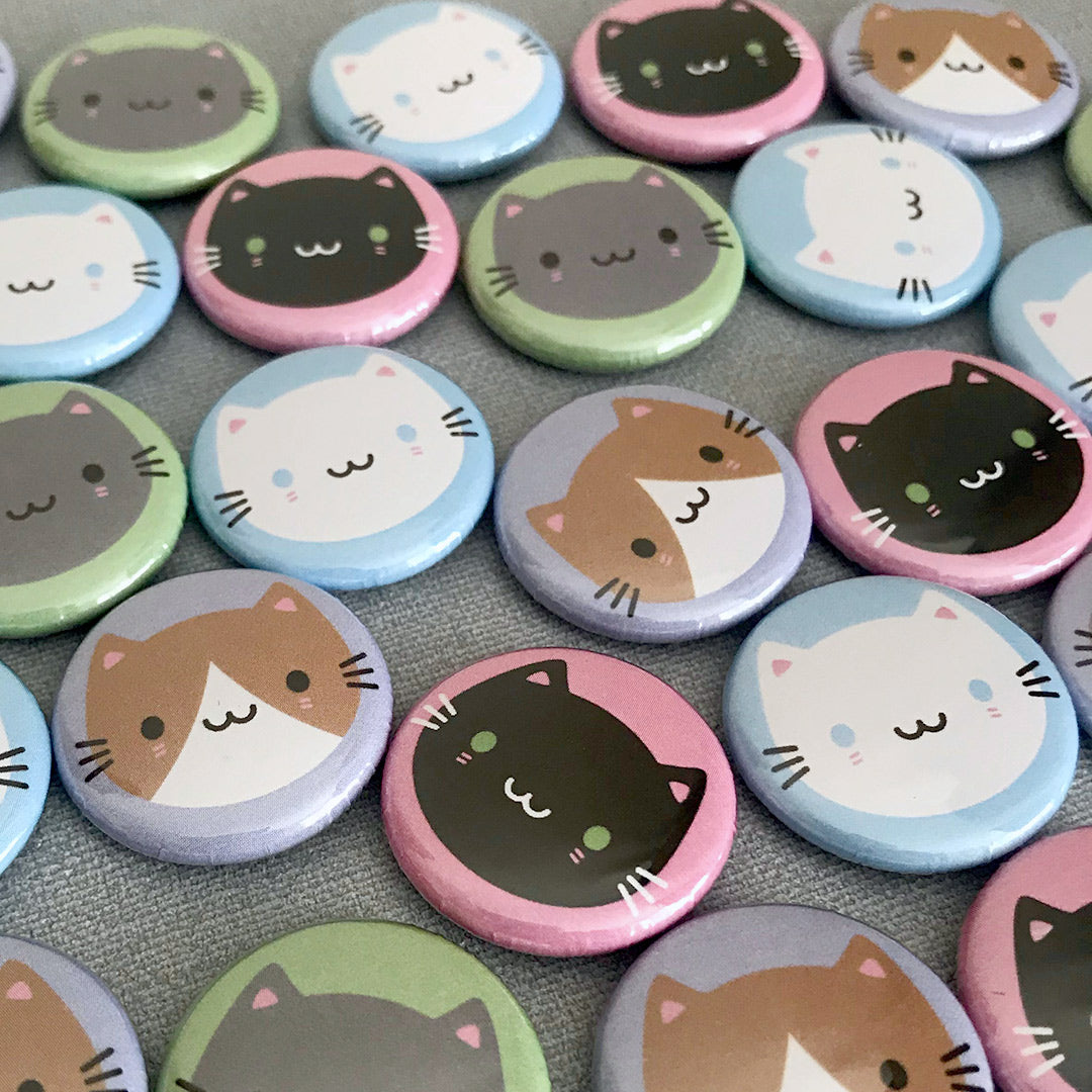 A mix of the finished Cute Cats badges laid out together