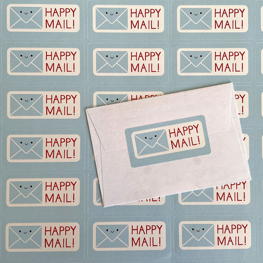 A sheet of Happy Mail stickers and one sealing a mini envelope