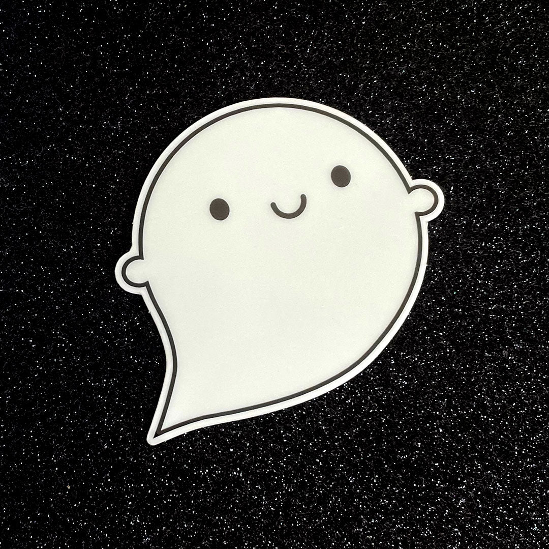 A die cut vinyl sticker of a happy ghost showing the normal daylight colour