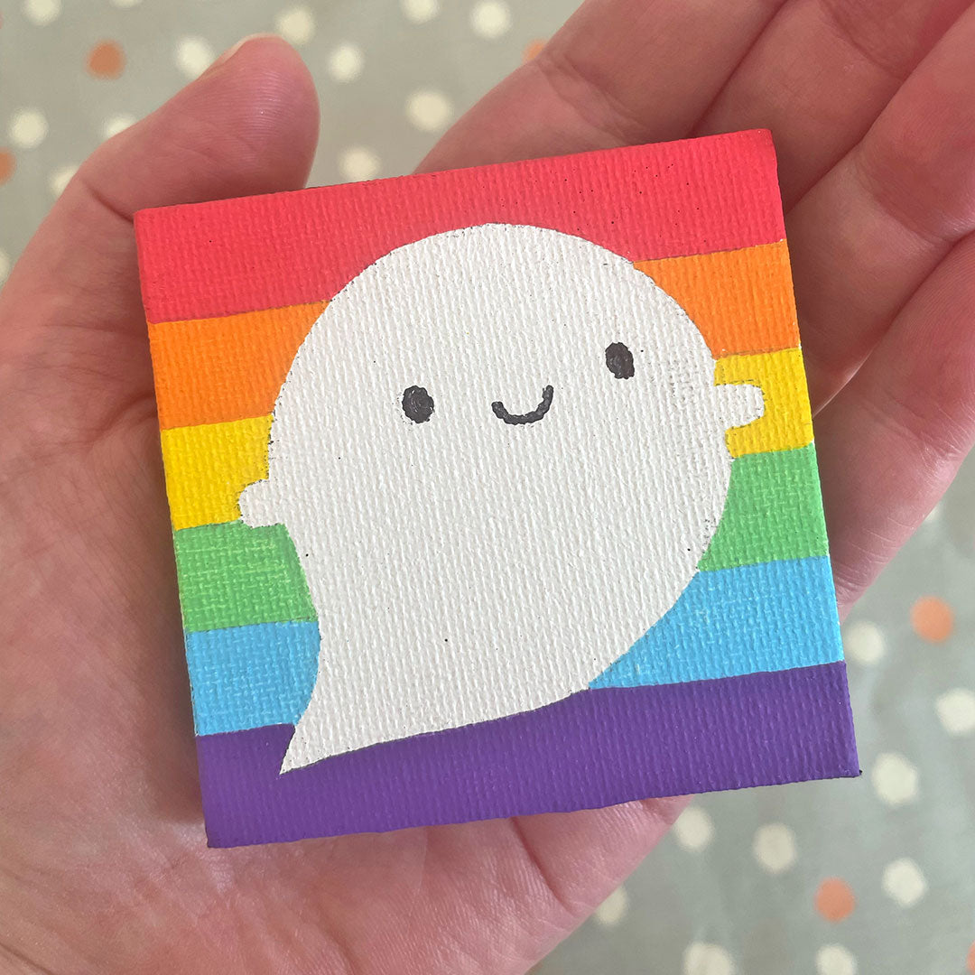 Holding the Rainbow Ghost painting in my hand to show the size