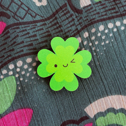 A winking kawaii Lucky Clover brooch made from ethically sourced, FSC certified wood