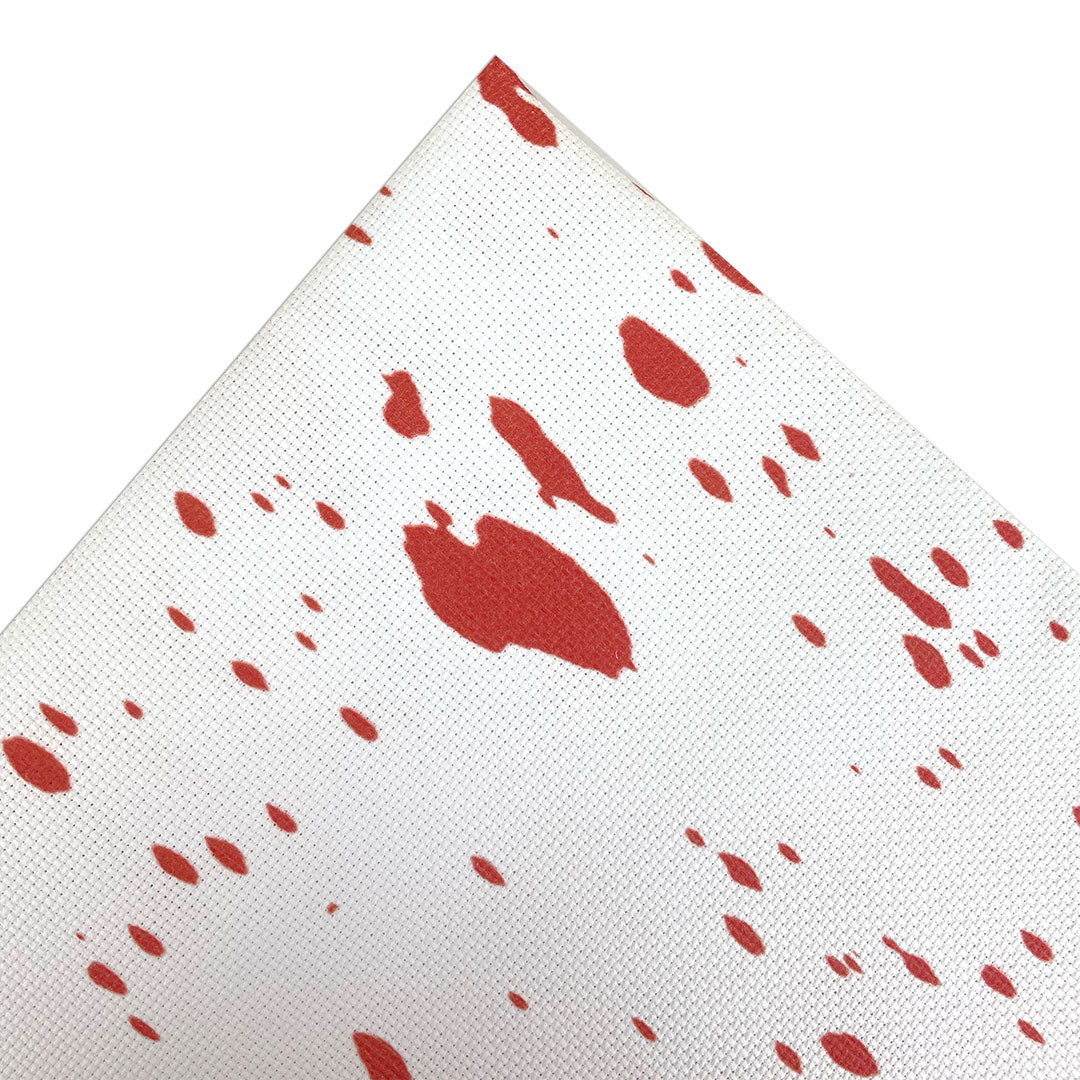 Aida fabric digitally printed with red blood spatter on a white background
