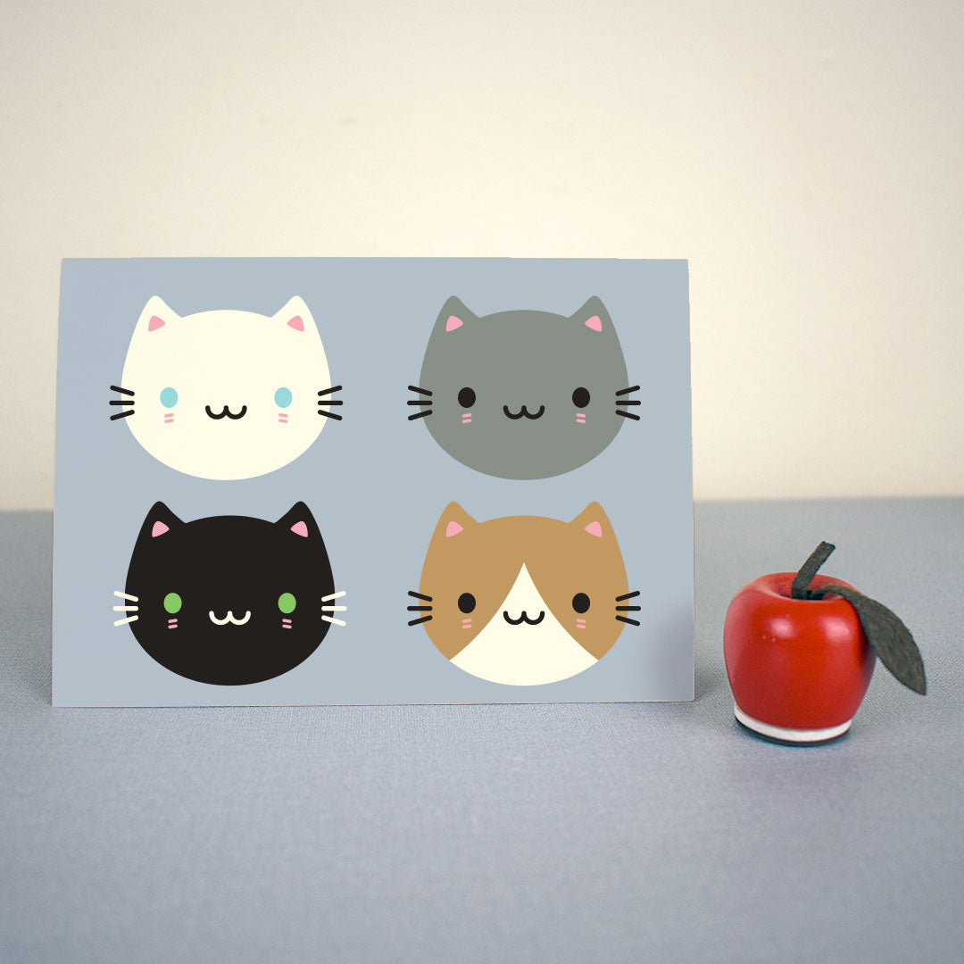 The card standing up with a small apple figure