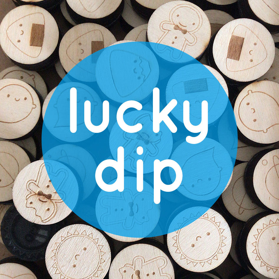 A pile of polymer stamps with a text overlay reading 'lucky dip'