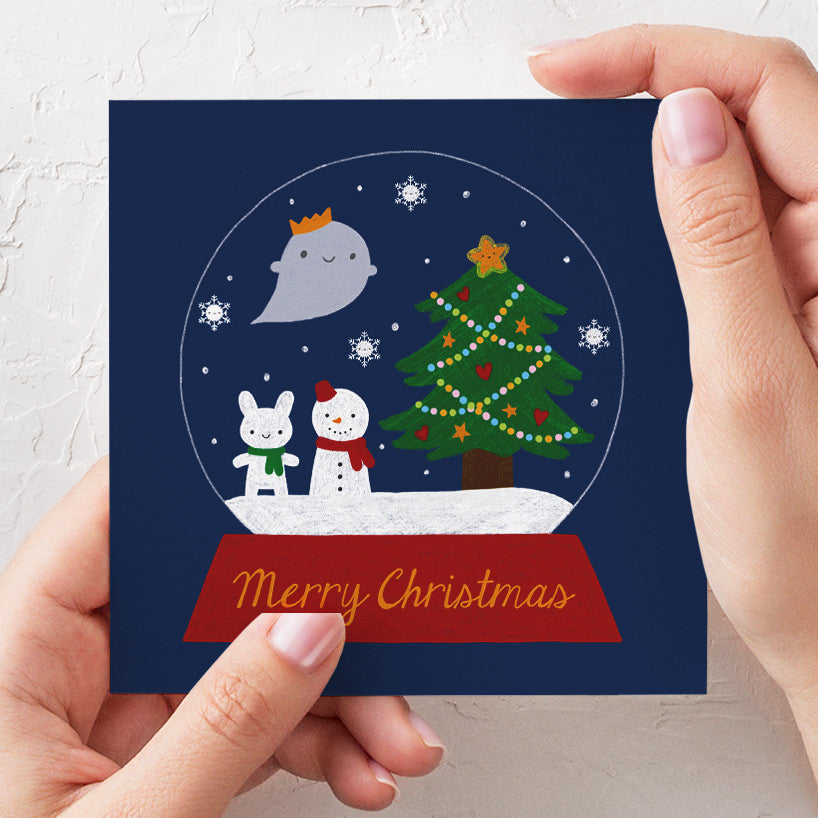 Mockup of card with hands to show scale (10cm square)